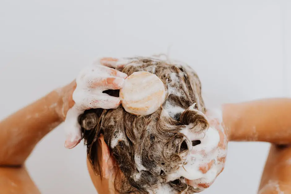 Hands lathering traditional shampoo in hair